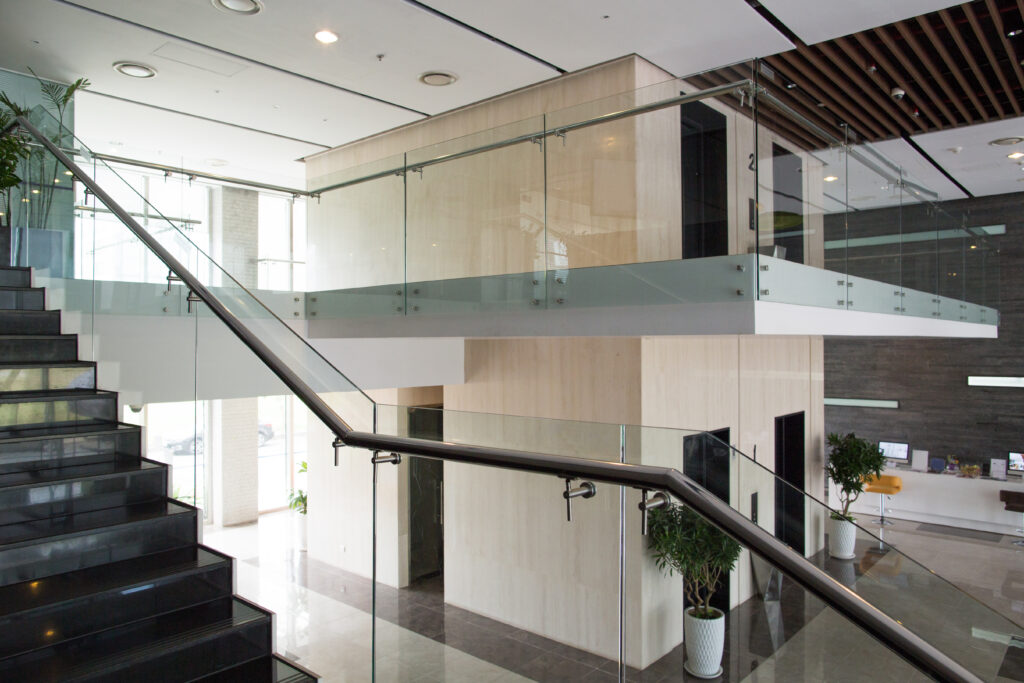 Image of glass railing with aluminum frame in an interior staircase
